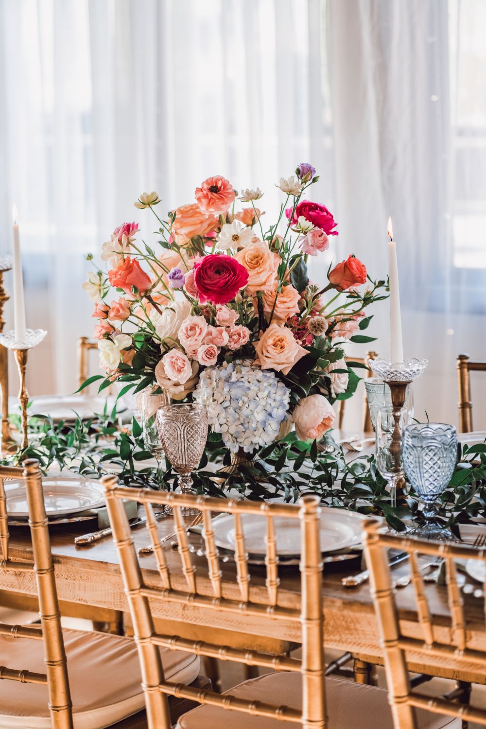 a beautiful bouquet of flowers on a dinner table at a rustic venue